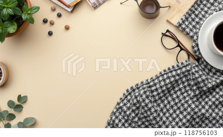A stylish workspace flatlay featuring a cup of coffee, a checkered cloth, a notebook, eyeglasses, and plants, creating a cozy and productive atmosphere. A stylish workspace flatlay featuring a cup of coffee, a checkered cloth, a notebook, eyeglasses, and plants, creating a cozy and productive atmosphere. 118756103