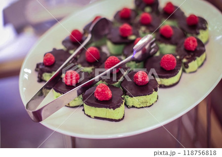 Beautiful multicolored decorated baked sweet tasty party cakes or catering cakes for party, bar dessert selection with cake, pie and pastries catering banquet, coffee break buffet at a conference 118756818