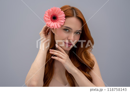 Portrait of a young cute woman in beige bra with a flower in hand 118758143