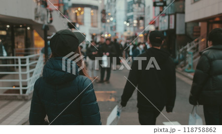 Tourists walking down a busy shopping street in shibuya, tokyo, japan. The area is famous for its many shops and restaurants 118758862
