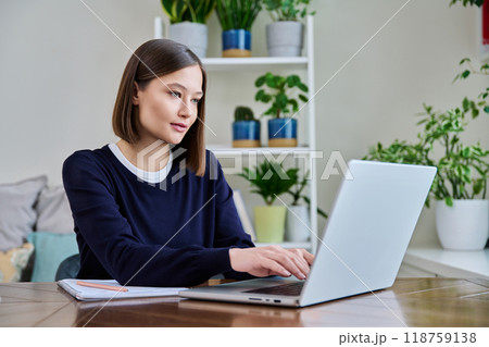 Young female using computer laptop for studying working Young female using computer laptop for studying working 118759138