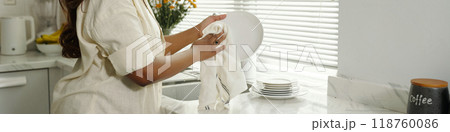 Cleaning Dishes in Modern Kitchen With Natural Light Coming In 118760086