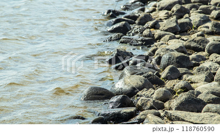 Rocky bank of a large river on a sunny day Rocky bank of a large river on a sunny day 118760590