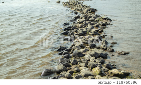 Rocky bank of a large river on a sunny day Rocky bank of a large river on a sunny day 118760596