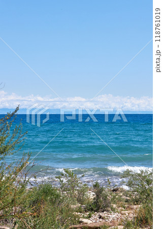 Wild coast of southern shore of Lake Issyk-Kul, summer vacation in Kyrgyzstan Wild coast of southern shore of Lake Issyk-Kul, summer vacation in Kyrgyzstan 118761019