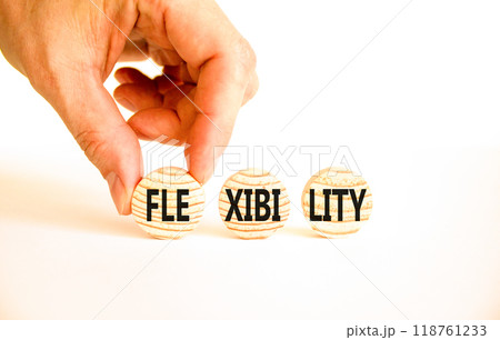 Flexibility symbol. Concept word Flexibility on beautiful wooden circles. Beautiful white table white background. Businessman hand. Business flexibility concept. Copy space. Flexibility symbol. Concept word Flexibility on beautiful wooden circles. Beautiful white table white background. Businessman hand. Business flexibility concept. Copy space. 118761233