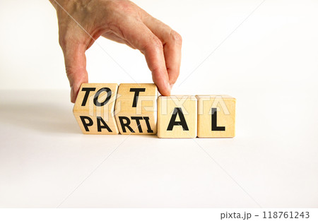 Total or partial symbol. Businessman turns beautiful wooden cubes and changes the word Partial to Total. Beautiful white table white background. Business and total or partial concept. Copy space. 118761243