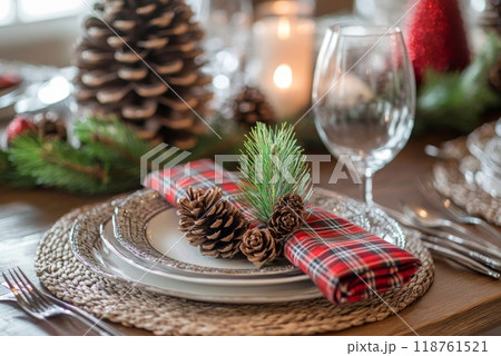 Christmas Table Setting with Pine Cones and Plaid Napkins 118761521