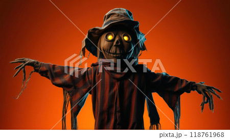Halloween scarecrow with glowing eyes in orange spooky background 118761968