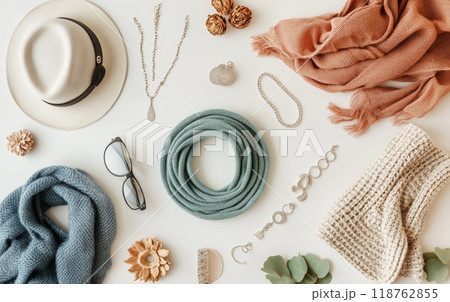 Elegant autumn fashion accessories arranged on white background. Hat, scarves, jewelry, and sunglasses create a cozy and trendy seasonal look 118762855