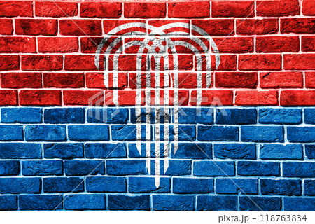 Flag of the city of Kansas City, Missouri, USA, on a background of a brick wall. Conceptual collage 118763834