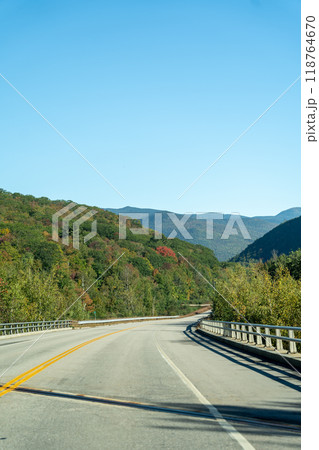 A winding road with view of mountains in White Mountain National Forest. A winding road with view of mountains in White Mountain National Forest. 118764670