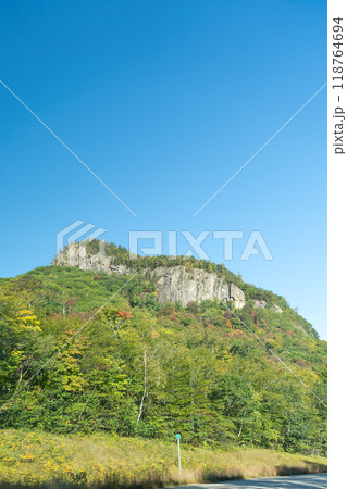 A winding road with view of mountains in White Mountain National Forest. 118764694