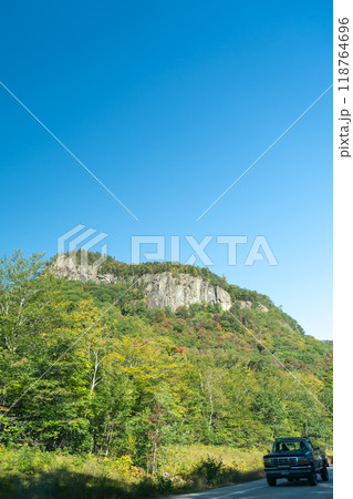 A winding road with view of mountains in White Mountain National Forest. 118764696