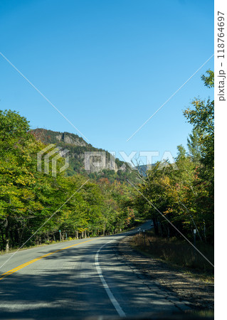 A winding road with view of mountains in White Mountain National Forest. A winding road with view of mountains in White Mountain National Forest. 118764697