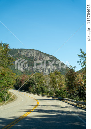 A winding road with view of mountains in White Mountain National Forest. A winding road with view of mountains in White Mountain National Forest. 118764698