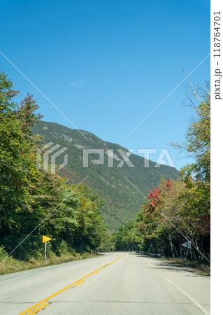 A winding road with view of mountains in White Mountain National Forest. 118764701