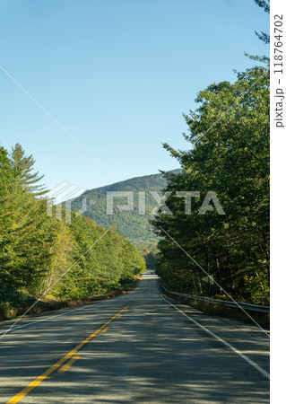 A winding road with view of mountains in White Mountain National Forest. 118764702