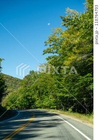A winding road with view of mountains in White Mountain National Forest. A winding road with view of mountains in White Mountain National Forest. 118764703