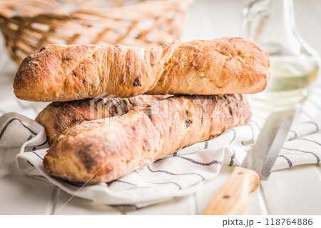 Crusty rustic baguette on white table. 118764886