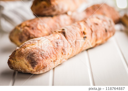Crusty rustic baguette on white table. 118764887