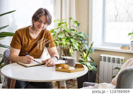 Stylish confident guy writing in journal 118766904