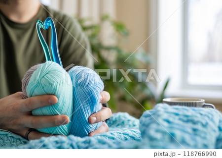 Crochet hooks folded in the shape of a heart and a skein of yarn. Crochet hooks folded in the shape of a heart and a skein of yarn. 118766990