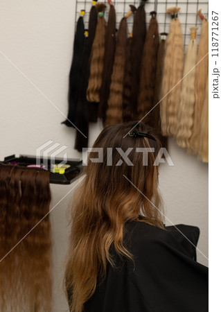 The hairdresser holds the strands of the client's hair in his hands. Barbershop The hairdresser holds the strands of the client's hair in his hands. Barbershop 118771267