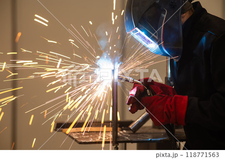 A man learns the craft of welding on a sample. A man learns the craft of welding on a sample. 118771563
