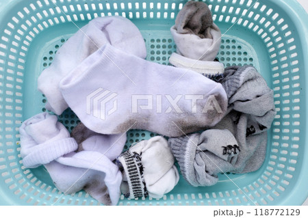 Dirty white socks in laundry basket 118772129