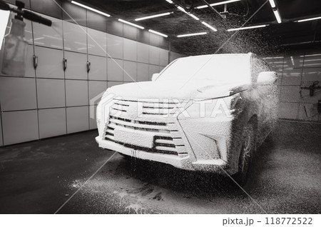 Black car covered in cleaning foam. Black car covered in cleaning foam. 118772522