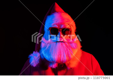 Portrait of Santa Claus in sunglasses in neon light. 118773001