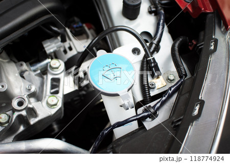 Close up of a blue cap of windscreen wiper fluid reservoir , windshield wiper reservoir Close up of a blue cap of windscreen wiper fluid reservoir , windshield wiper reservoir 118774924