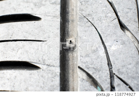 Tire tread wear indicator, Close up of tire with tire tread wear indicator showing on tread grooves Tire tread wear indicator, Close up of tire with tire tread wear indicator showing on tread grooves 118774927