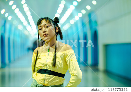 Portrait of an Asian young woman in a subway crossing. Portrait of an Asian young woman in a subway crossing. 118775331