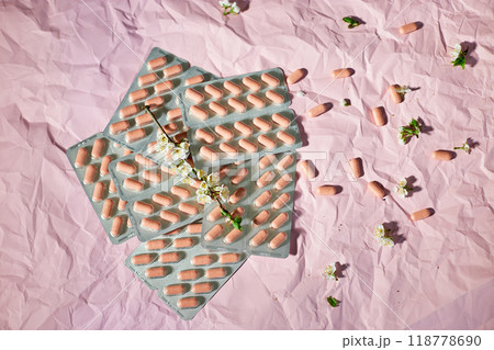 Overhead View of Multiple Blister Packs of Medication on a Crumpled Pink Surface Overhead View of Multiple Blister Packs of Medication on a Crumpled Pink Surface 118778690