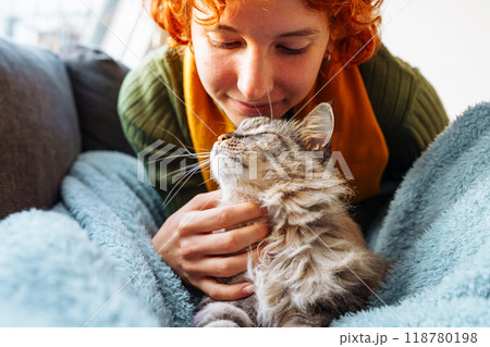 portrait red-haired attractive young woman with fluffy big cat 118780198