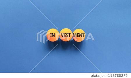 Investment symbol. Concept word Investment on beautiful yellow ping-pong balls. Beautiful blue table blue background. Business investment concept. Copy space. 118780273