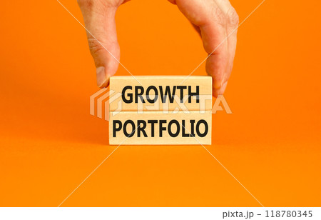 Growth portfolio symbol. Concept words Growth portfolio on beautiful wooden block. Beautiful orange paper background. Businessman hand. Business Growth portfolio concept. Copy space. Growth portfolio symbol. Concept words Growth portfolio on beautiful wooden block. Beautiful orange paper background. Businessman hand. Business Growth portfolio concept. Copy space. 118780345