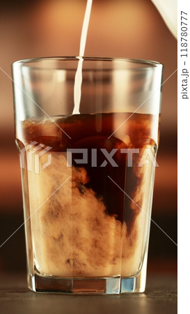 Pouring Milk into Coffee Drink in Detail. Pouring Milk into Coffee Drink in Detail. 118780777