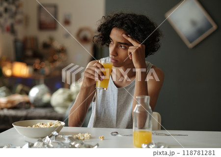 Touching head and drinking orange juice 118781281
