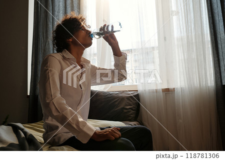 Guy having refreshment after booze Guy having refreshment after booze 118781306