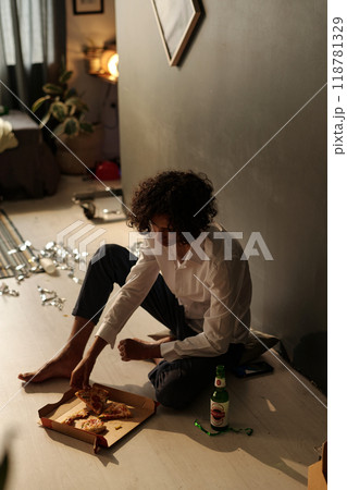 Sick guy taking slice of takeaway pizza 118781329
