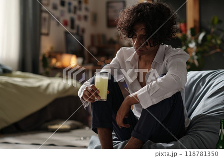 Looking at glass with effervescent pill 118781350