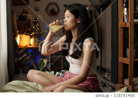 Girl with hangover taking dissolved pill 118781408