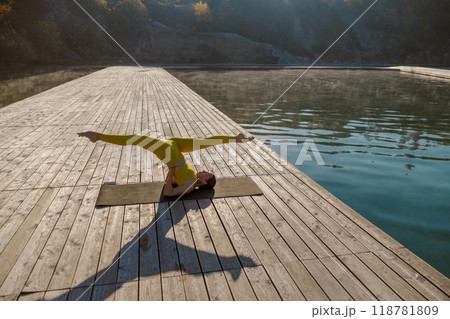 Engaging in a Serene Yoga Practice by the Water while Watching the Sunrise is Refreshing Engaging in a Serene Yoga Practice by the Water while Watching the Sunrise is Refreshing 118781809