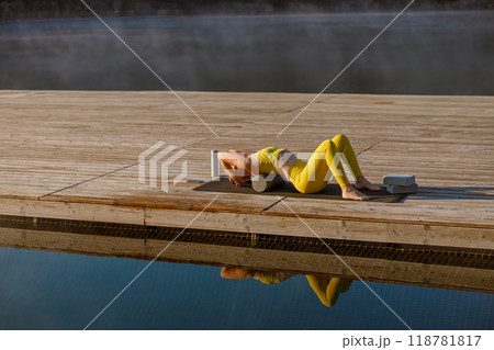 Engaging in a Serene Yoga Practice by the Water at Sunrise is truly refreshing and invigorating 118781817