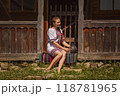 A Traditional Ukrainian Woman Enjoying a Relaxing Moment at a Charming Rustic Home 118781965