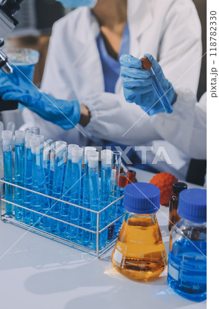 Scientist using microscope in laboratory. Close-up of a researcher's hands adjusting a modern microscope in a lab setting. Science concept Scientist using microscope in laboratory. Close-up of a researcher's hands adjusting a modern microscope in a lab setting. Science concept 118782330