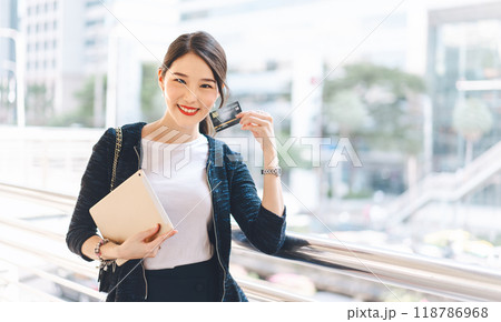 Young adult asian woman using creadit card and smartphone for online shopping and digital wallet Young adult asian woman using creadit card and smartphone for online shopping and digital wallet 118786968